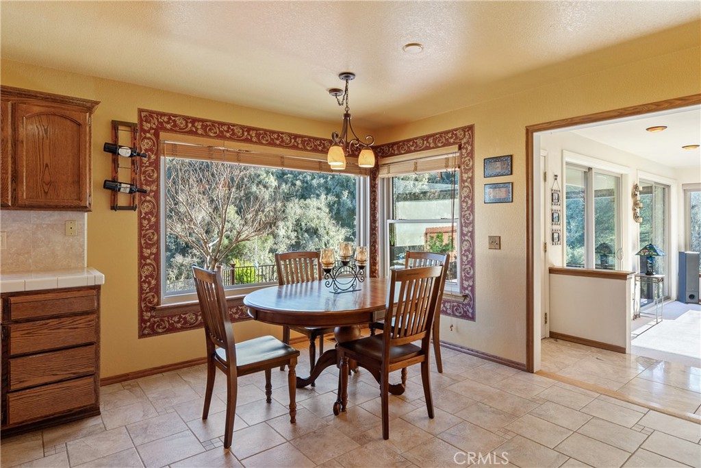 5145 Northfork Place Paso Robles, CA 93446 - Photo 19 of 62 a dining room with furniture a chandelier and wooden floor