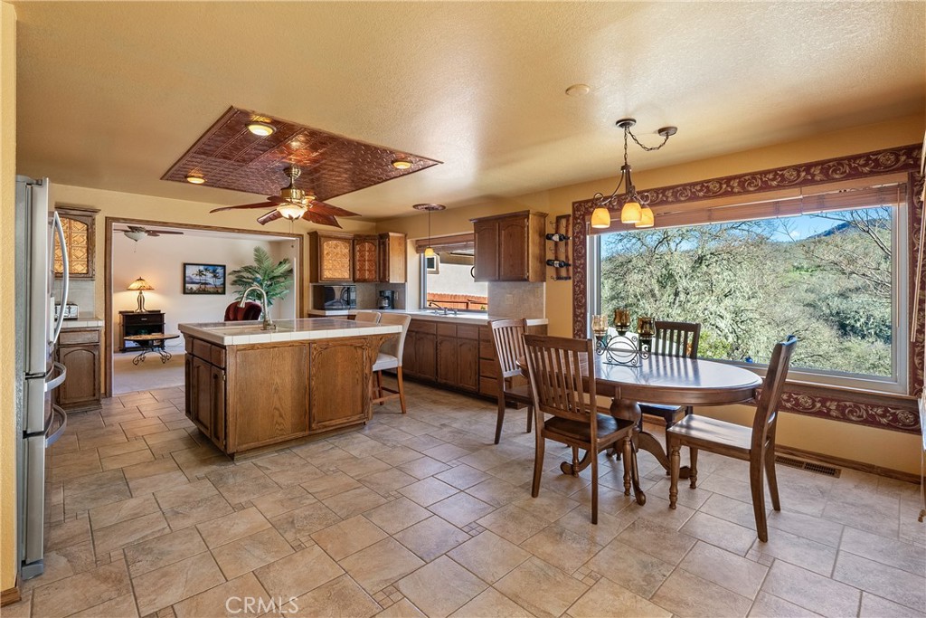 5145 Northfork Place Paso Robles, CA 93446 - Photo 20 of 62 a view of a dining room with furniture large windows and kitchen view