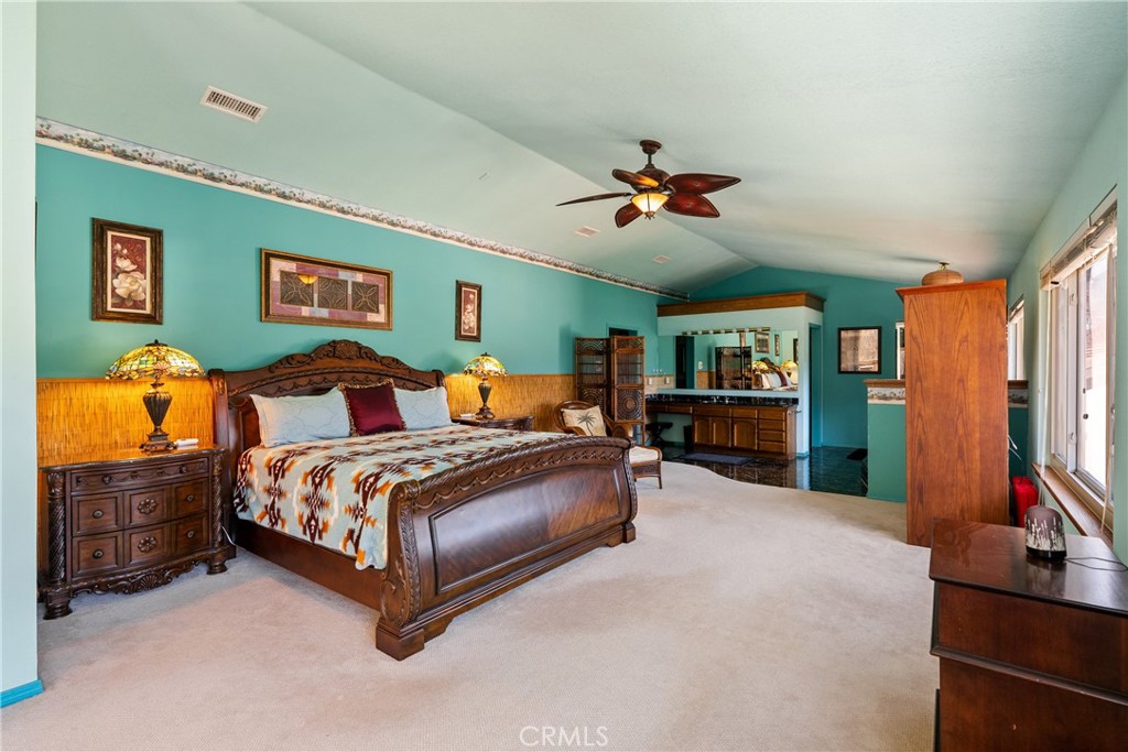 5145 Northfork Place Paso Robles, CA 93446 - Photo 36 of 62 a spacious bedroom with a bed a dresser and book self