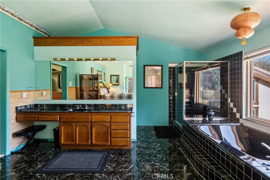 5145 Northfork Place Paso Robles, CA 93446 - Photo 39 of 62 a bathroom with a granite countertop sink and a mirror
