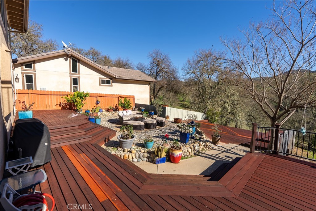 5145 Northfork Place Paso Robles, CA 93446 - Photo 47 of 62 a view of a roof deck with table and chairs a barbeque with wooden floor and fence
