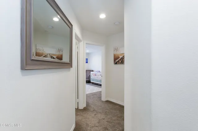 a view of a hallway with bathroom