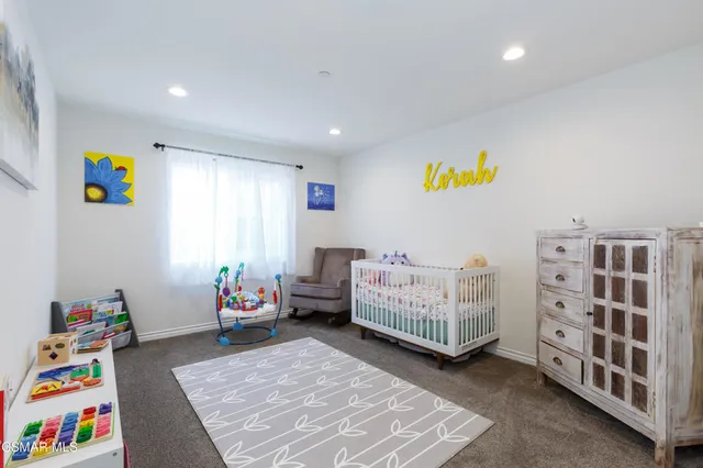 a bedroom with furniture and a book shelf