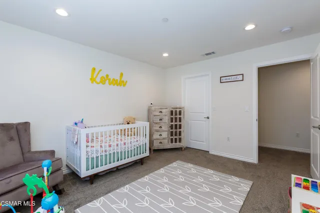 a bedroom with furniture and a rug