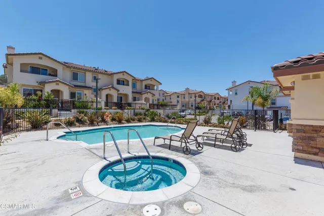 a view of a patio with a table and chairs