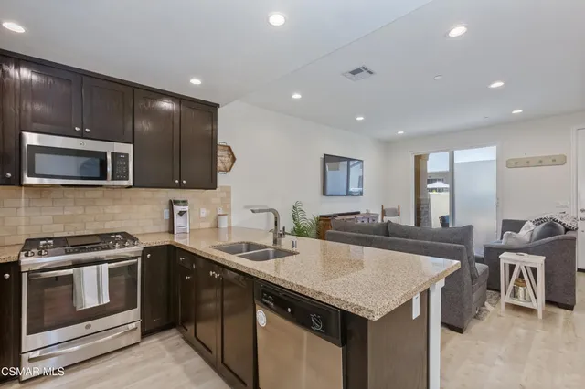 a kitchen with a stove sink and microwave