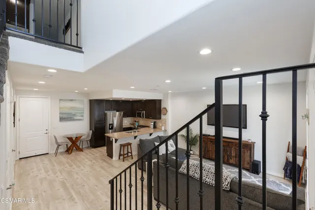 a view of a hallway with workspace and furniture