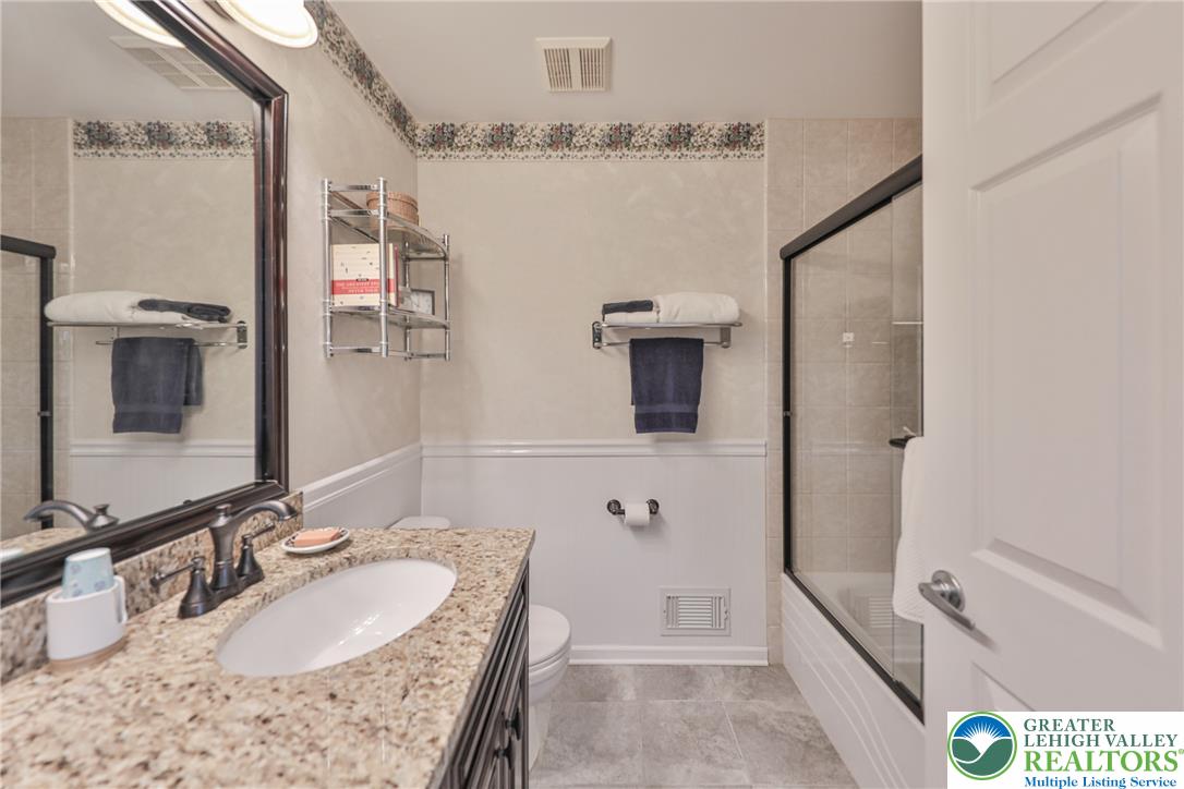 163 Muirfield Way Easton, PA 18042 - Photo 32 of 48 a bathroom with a granite countertop sink a mirror and shower