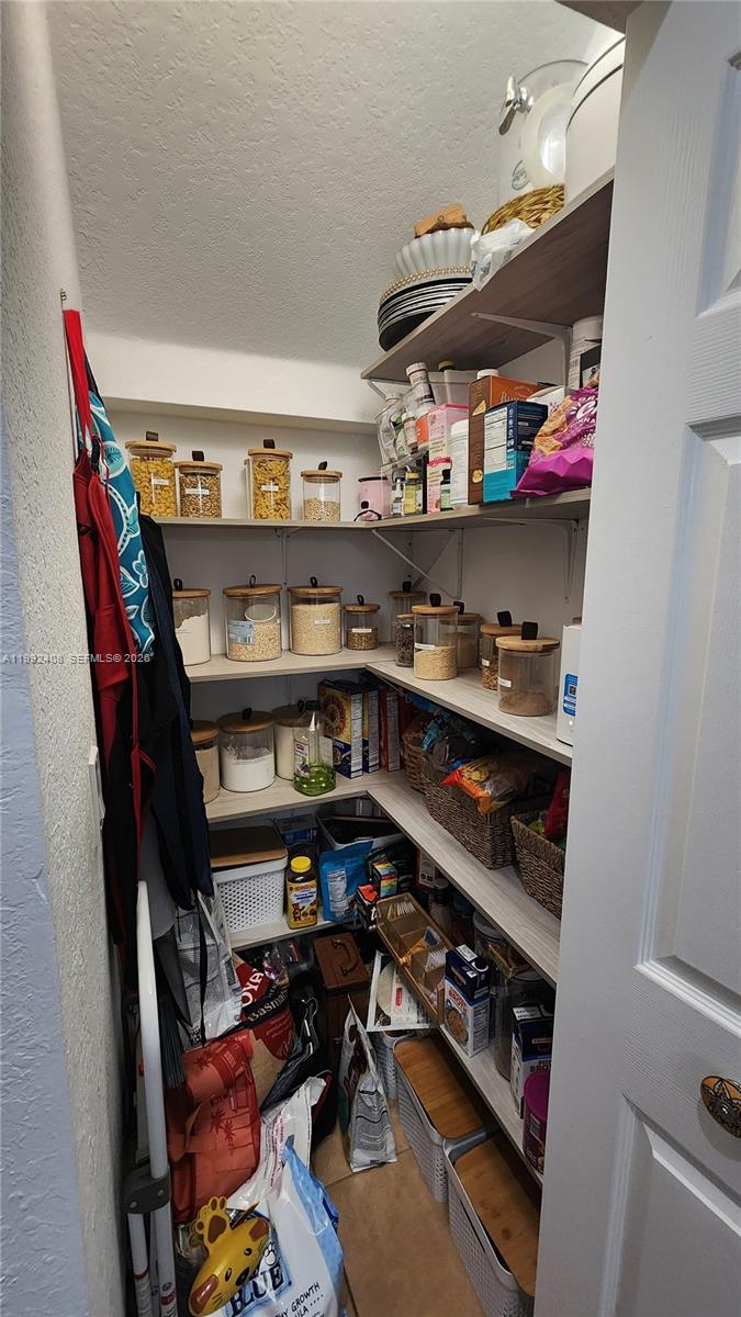 2607 Southwest 99th Way Miramar, FL 33025 - Photo 9 of 50 a view of walk in closet with clothes and shoes