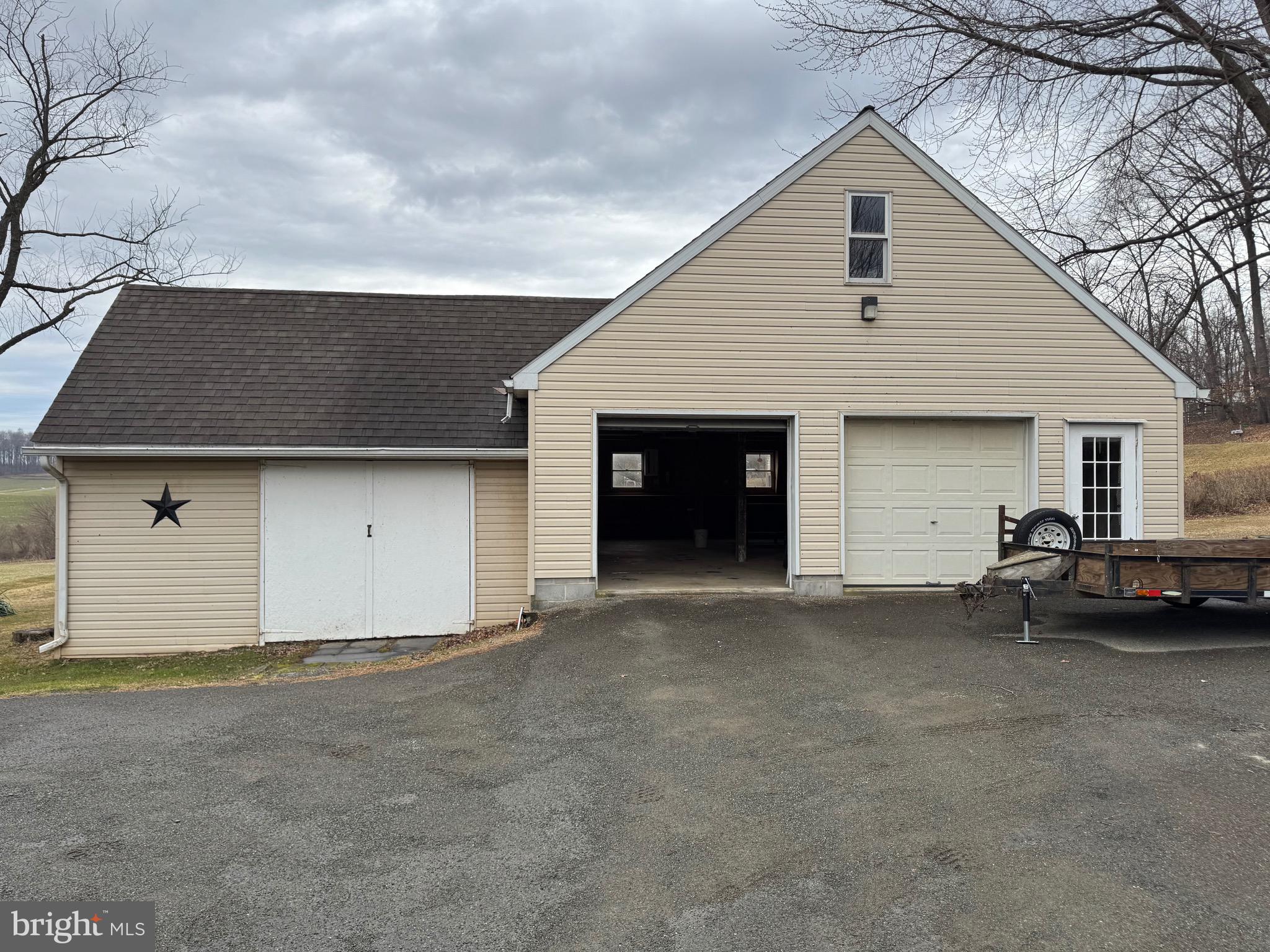 1009 Dry Wells Road Quarryville, PA 17566 - Photo 16 of 17 a view of a house with a yard and garage