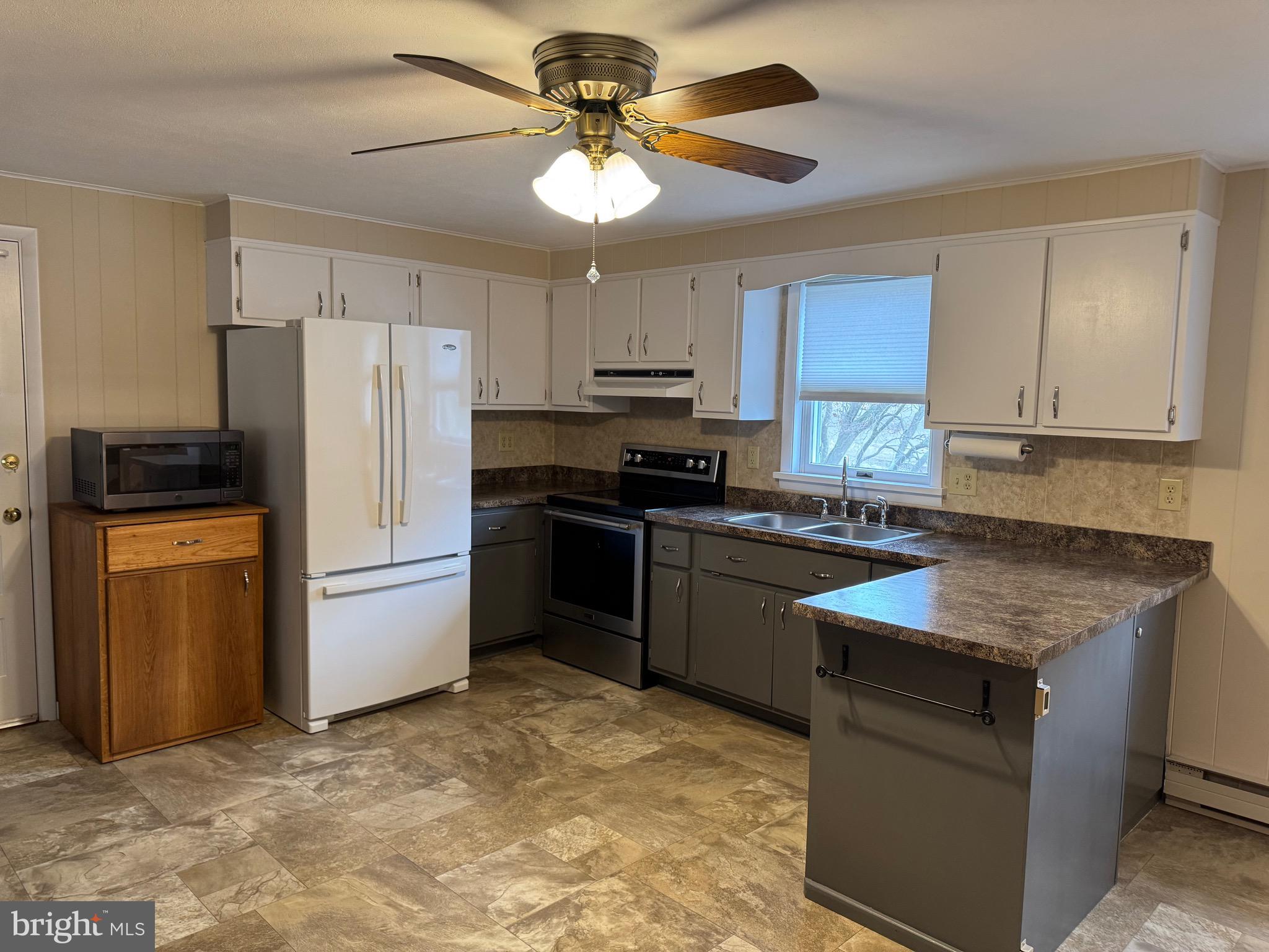 1009 Dry Wells Road Quarryville, PA 17566 - Photo 8 of 17 a kitchen with a stove a refrigerator and a sink