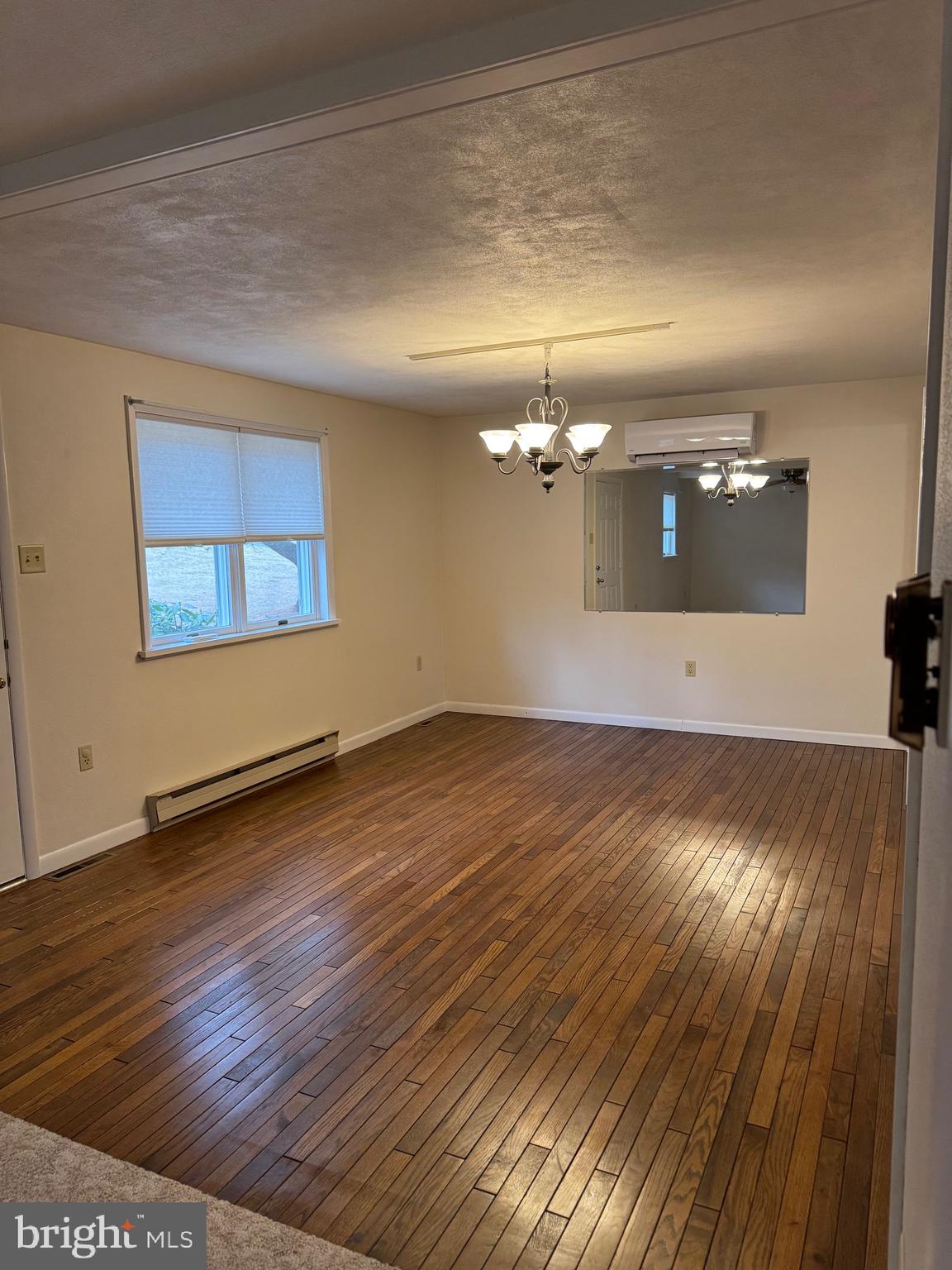 1009 Dry Wells Road Quarryville, PA 17566 - Photo 10 of 17 an empty room with wooden floor and windows