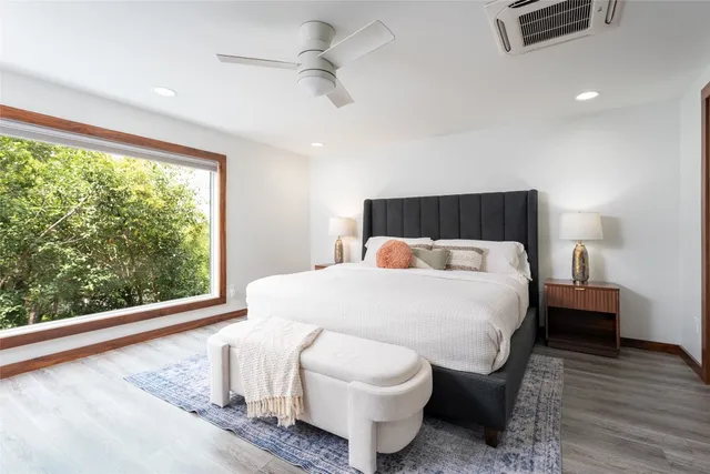 a bed room with a bed and a large window