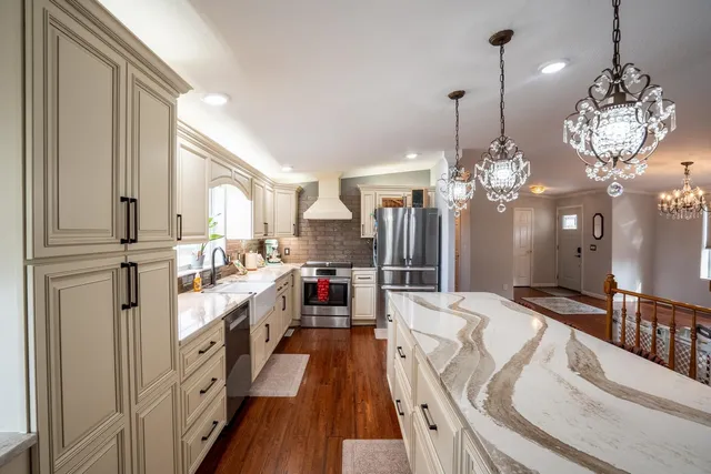 a view of a livingroom with wooden floor and a flat screen tv
