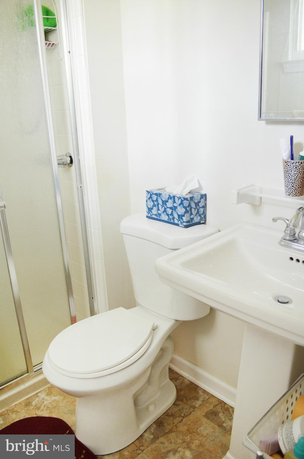 5534 Callander Drive Springfield, VA 22151 - Photo 11 of 20 a white toilet sitting next to a bathroom sink
