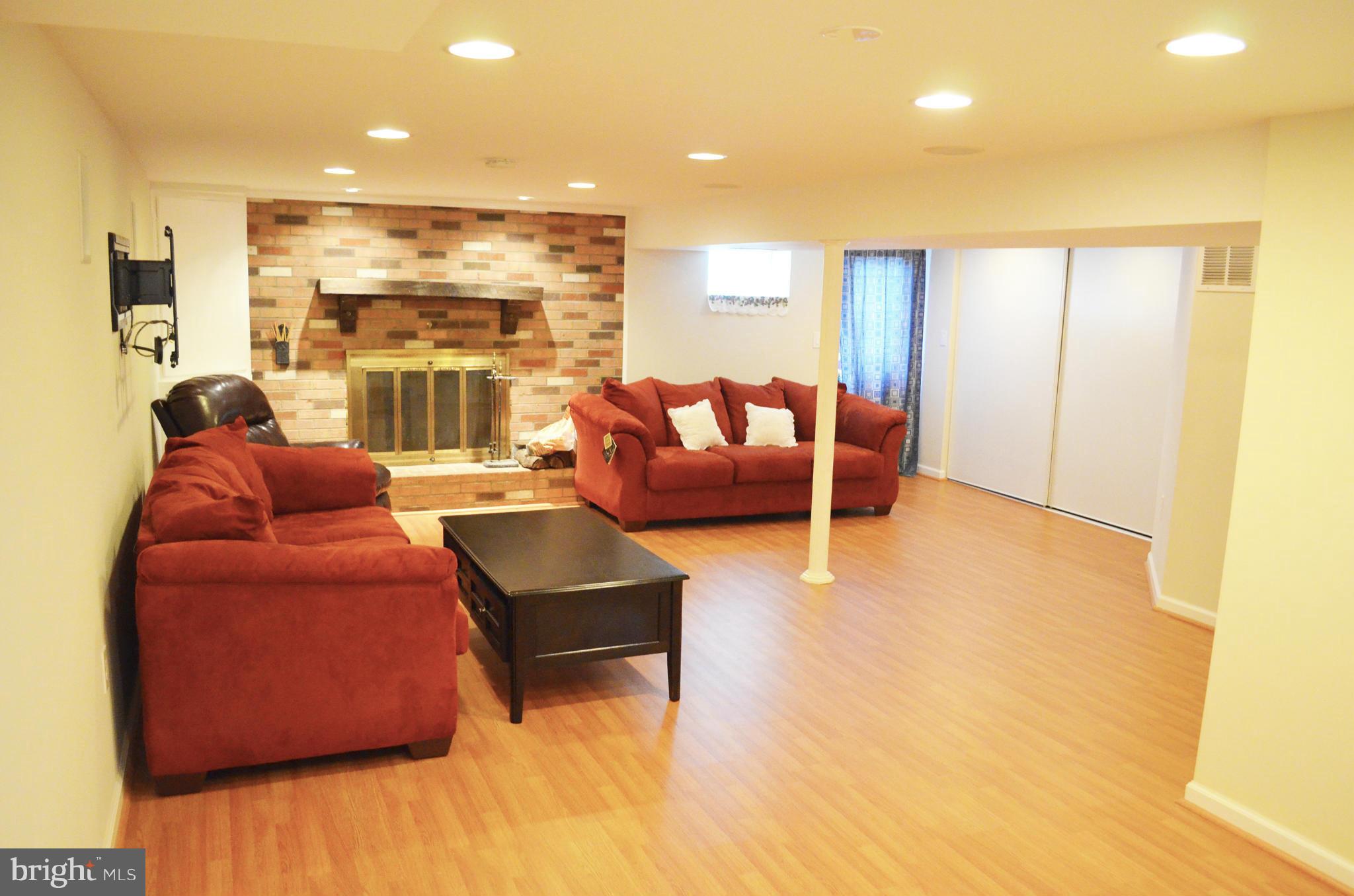 5534 Callander Drive Springfield, VA 22151 - Photo 16 of 20 a living room with furniture wooden floor and a large window