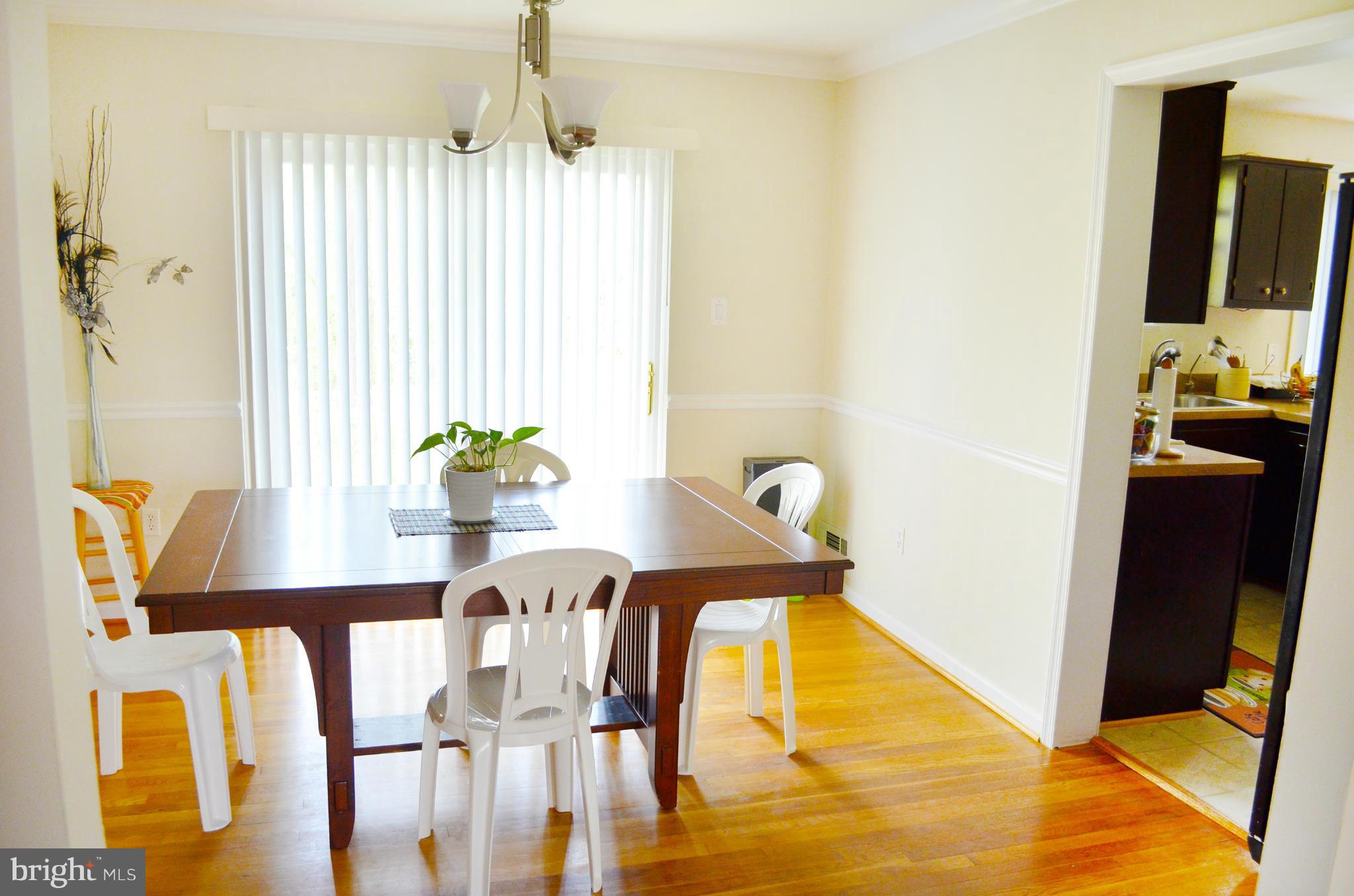 5534 Callander Drive Springfield, VA 22151 - Photo 5 of 20 a view of a dining room with furniture and a flat screen tv