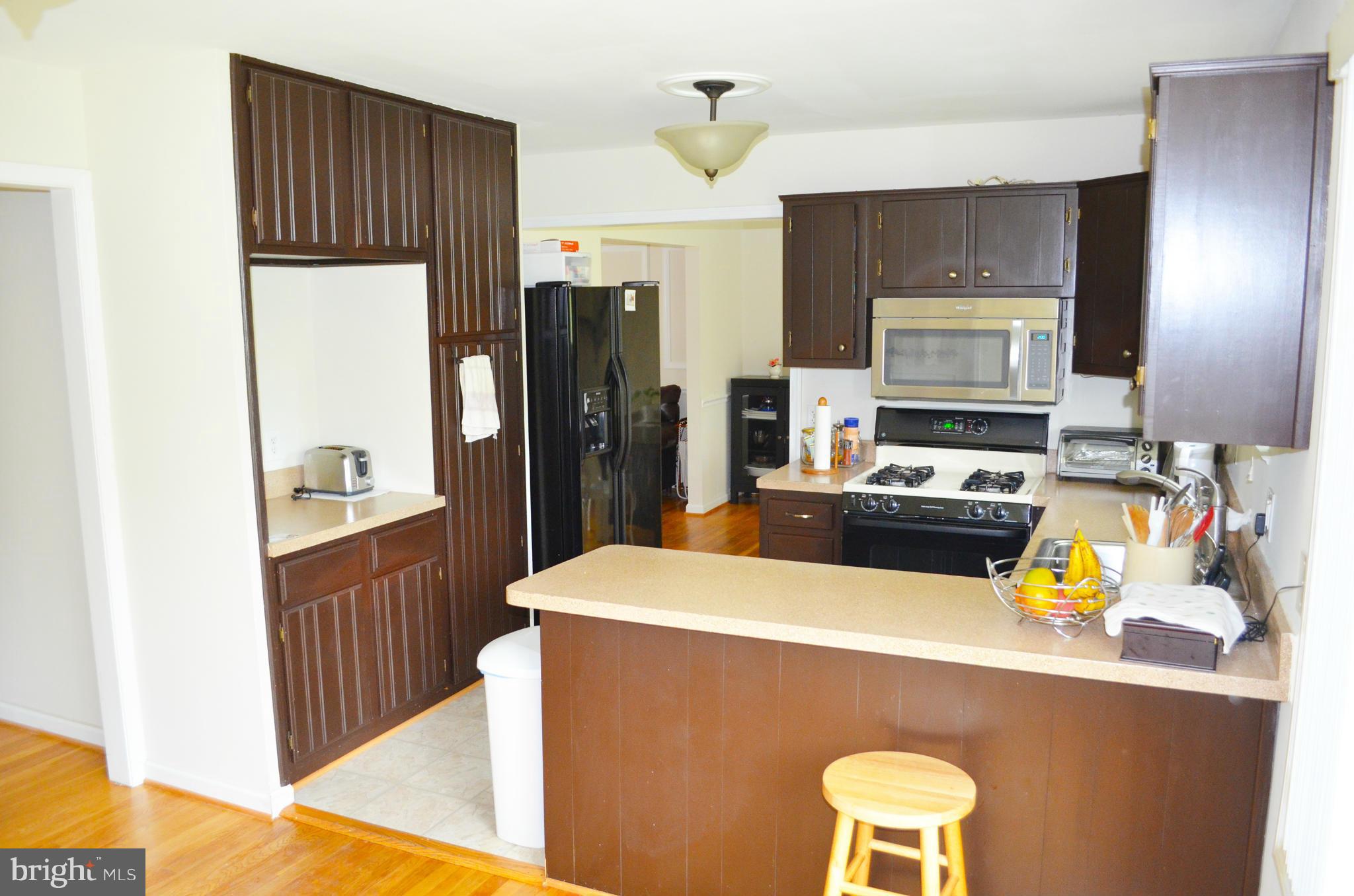 5534 Callander Drive Springfield, VA 22151 - Photo 7 of 20 a kitchen with a refrigerator a stove top oven a sink and dishwasher