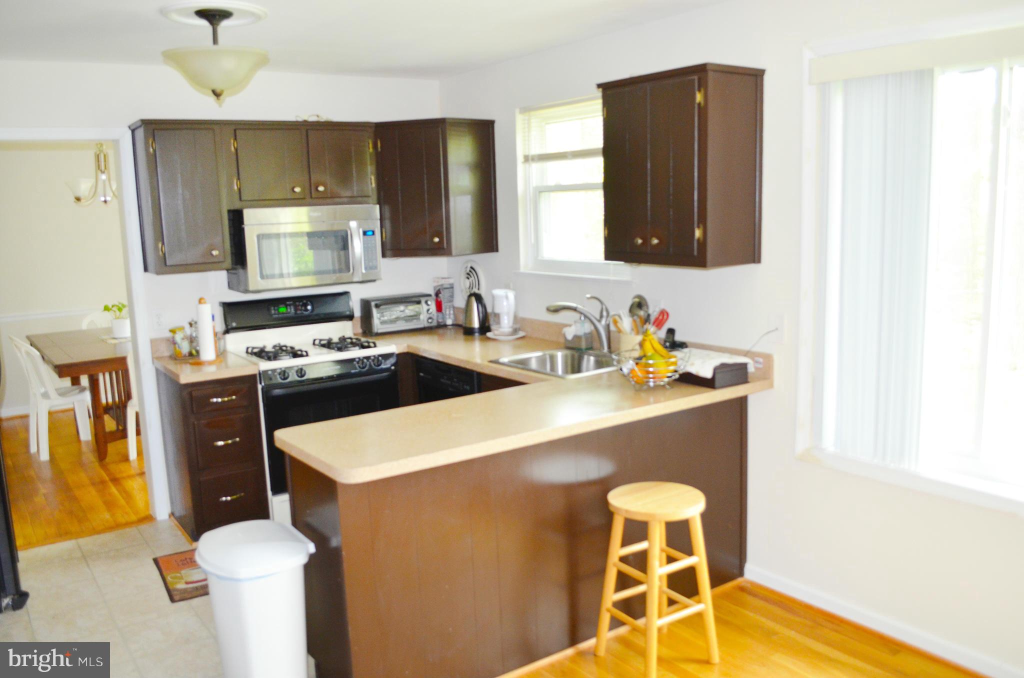 5534 Callander Drive Springfield, VA 22151 - Photo 8 of 20 a kitchen with a sink a stove and cabinets