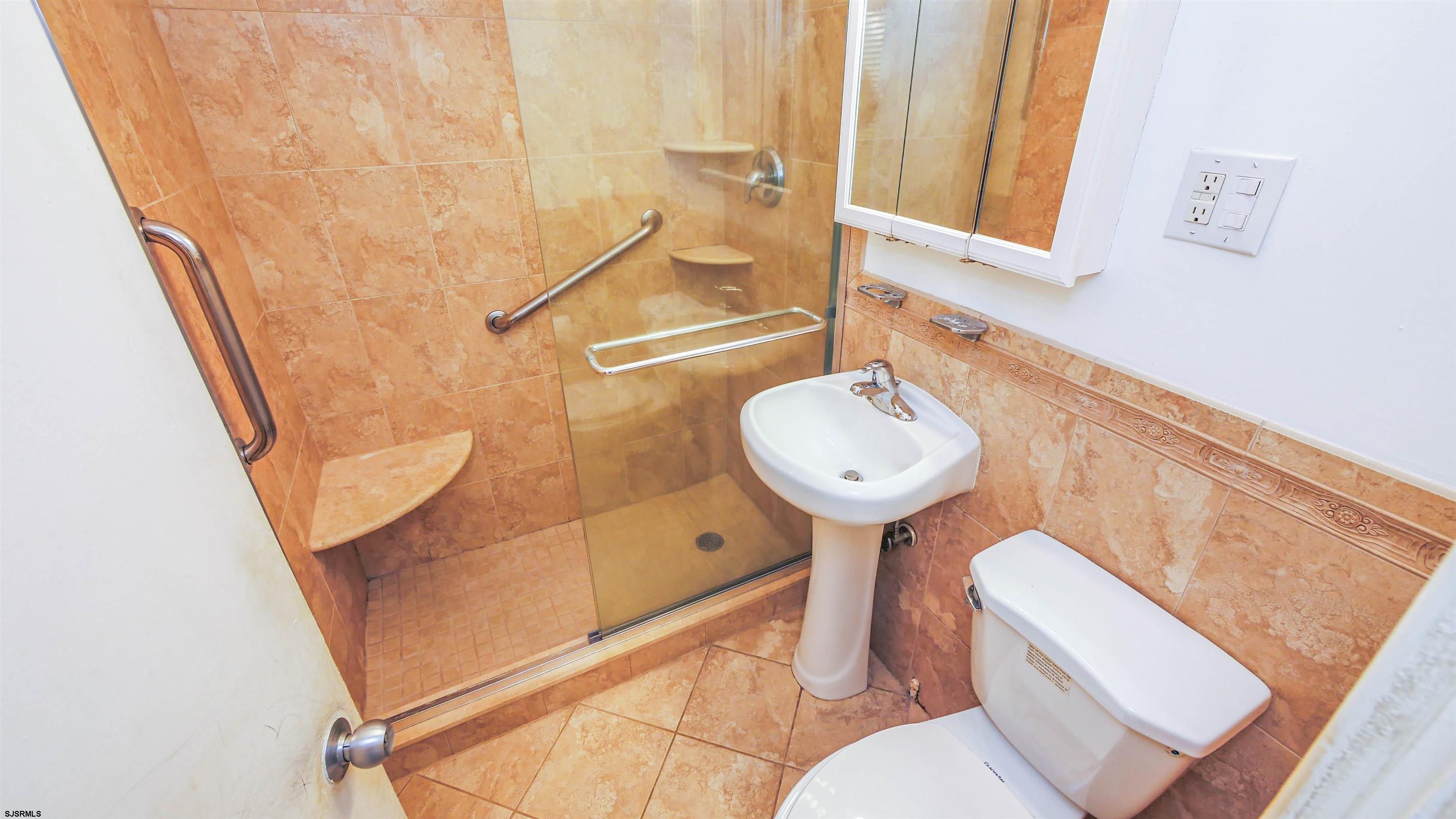 101 South Raleigh Avenue, Unit 521 Atlantic City, NJ 08401 - Photo 18 of 27 a bathroom with a sink a toilet and shower