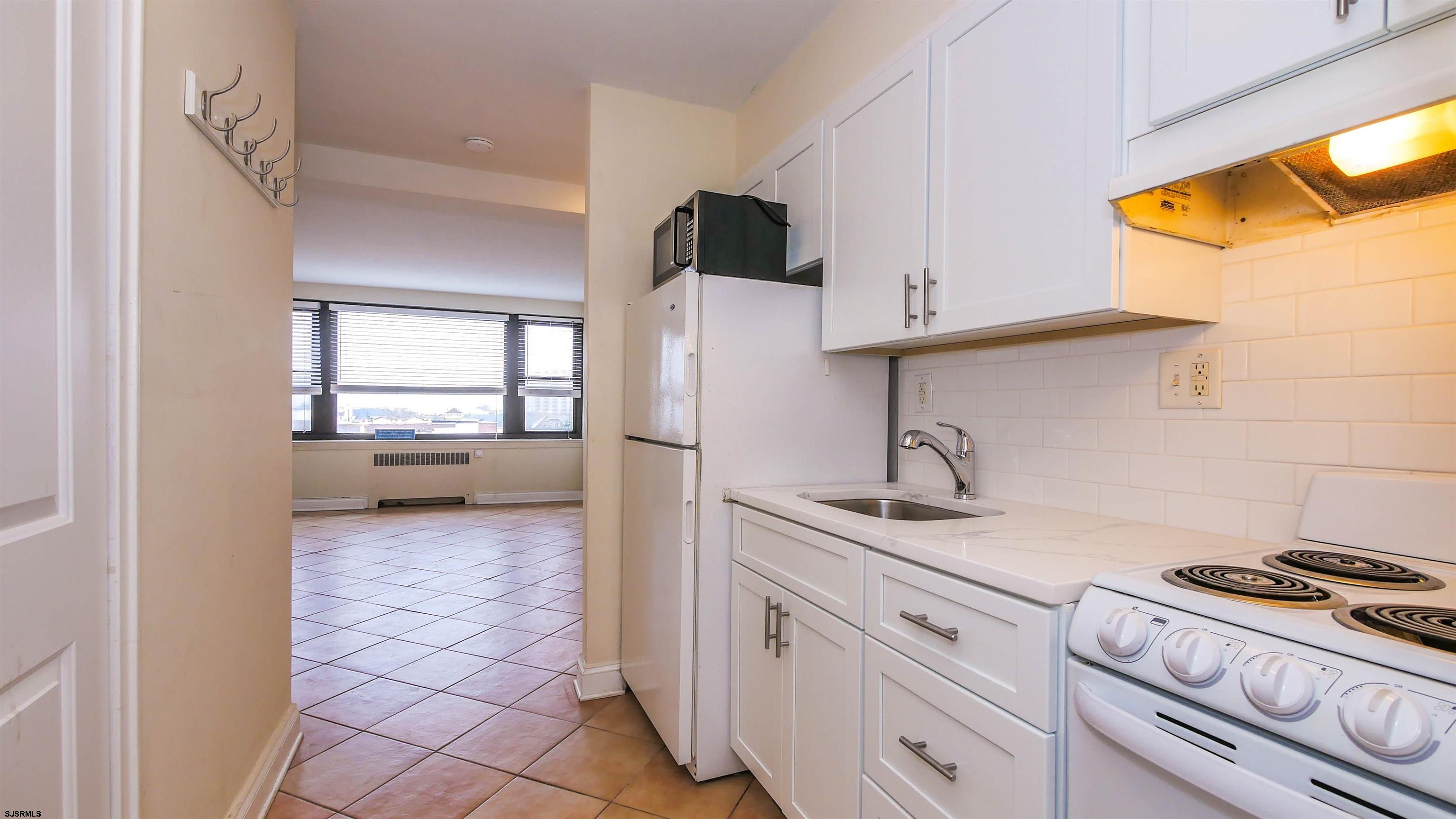 101 South Raleigh Avenue, Unit 521 Atlantic City, NJ 08401 - Photo 6 of 27 a kitchen with a sink a stove and a refrigerator