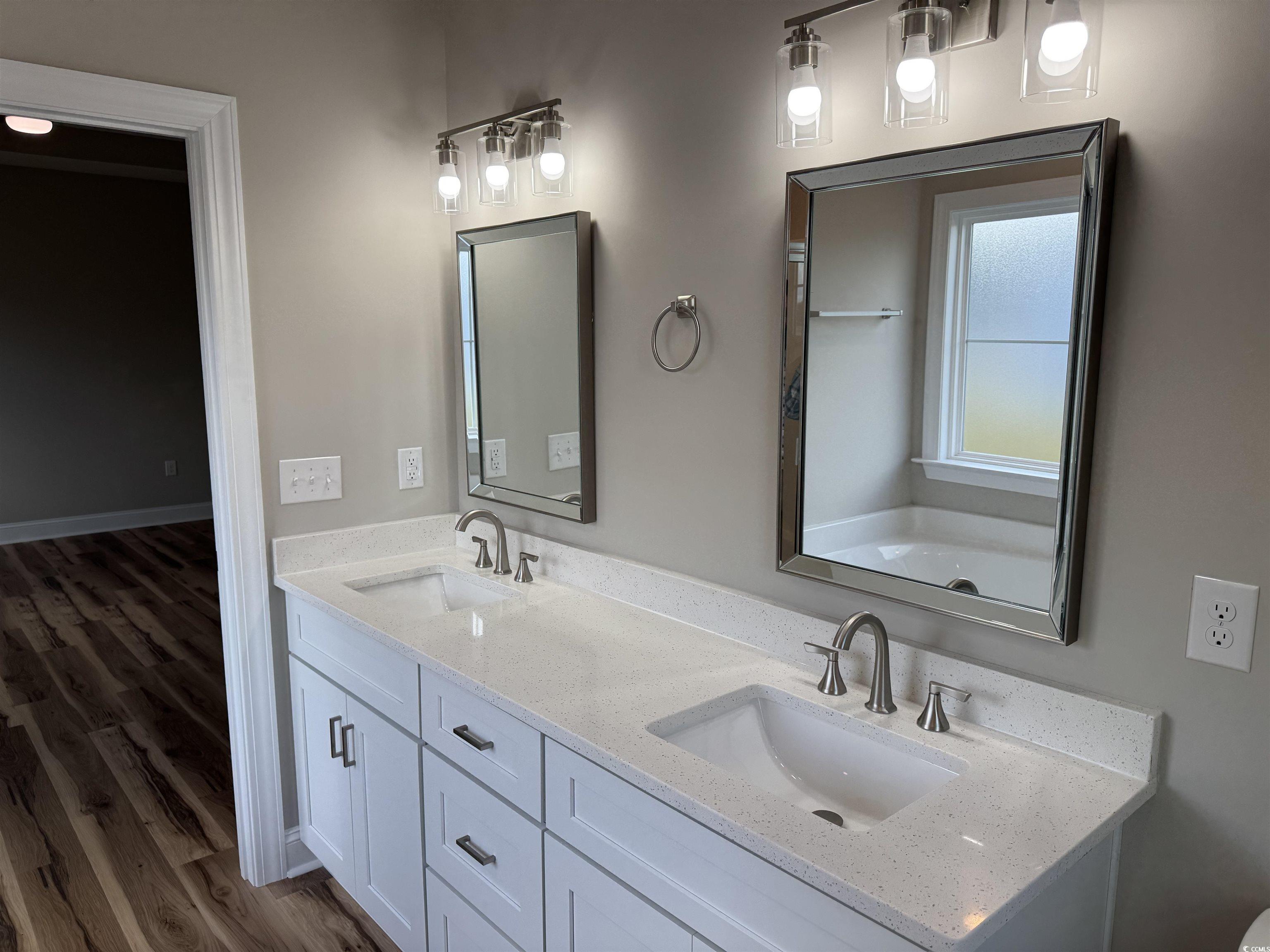 4963 Dupont Road Aynor, SC 29511 - Photo 10 of 18 Bathroom featuring double vanity and dark wood-style floors
