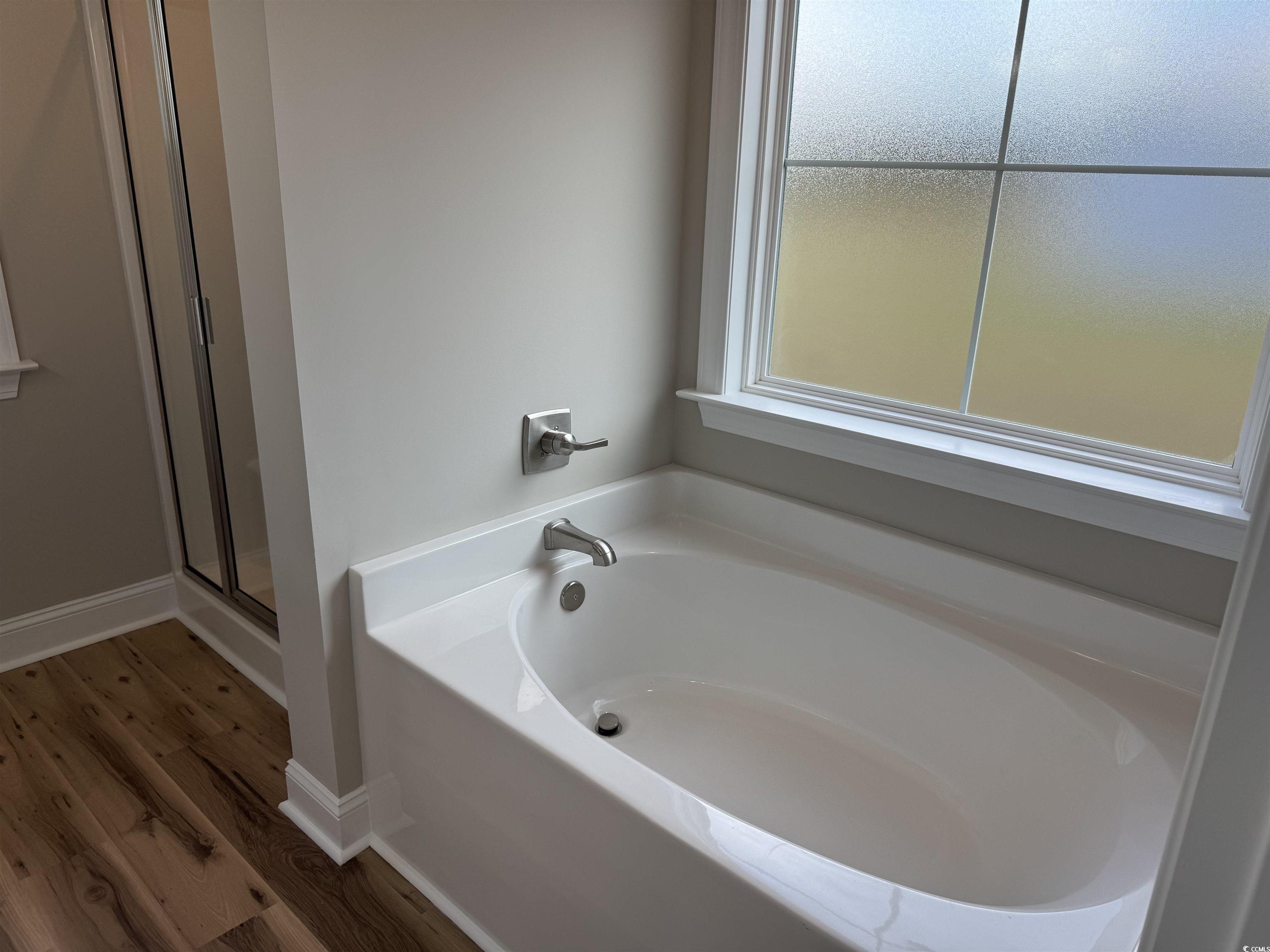 4963 Dupont Road Aynor, SC 29511 - Photo 12 of 18 Full bath featuring a bath, a stall shower, and wood finished floors
