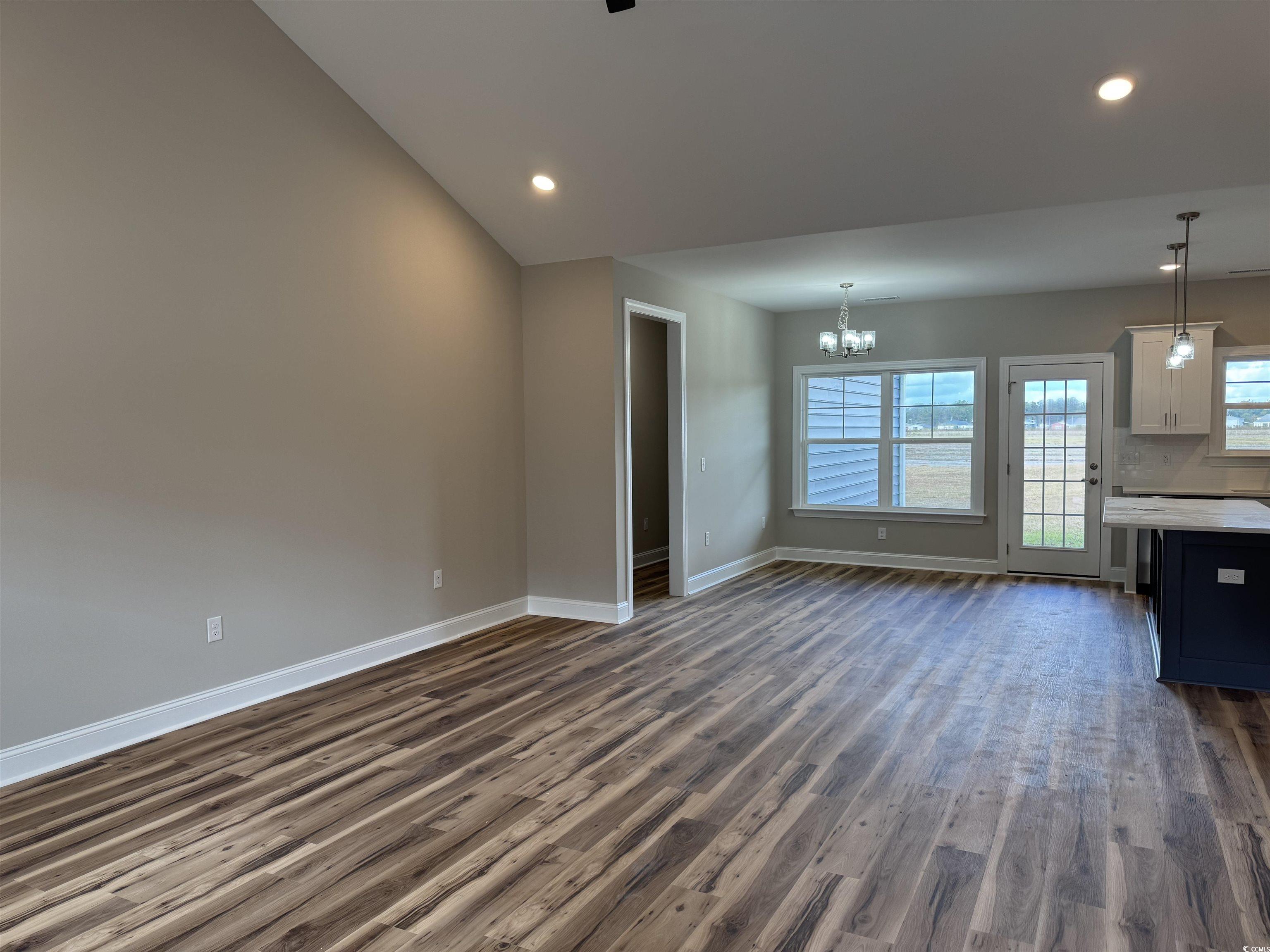 4963 Dupont Road Aynor, SC 29511 - Photo 3 of 18 Unfurnished living room with dark wood finished floors, recessed lighting, and a chandelier