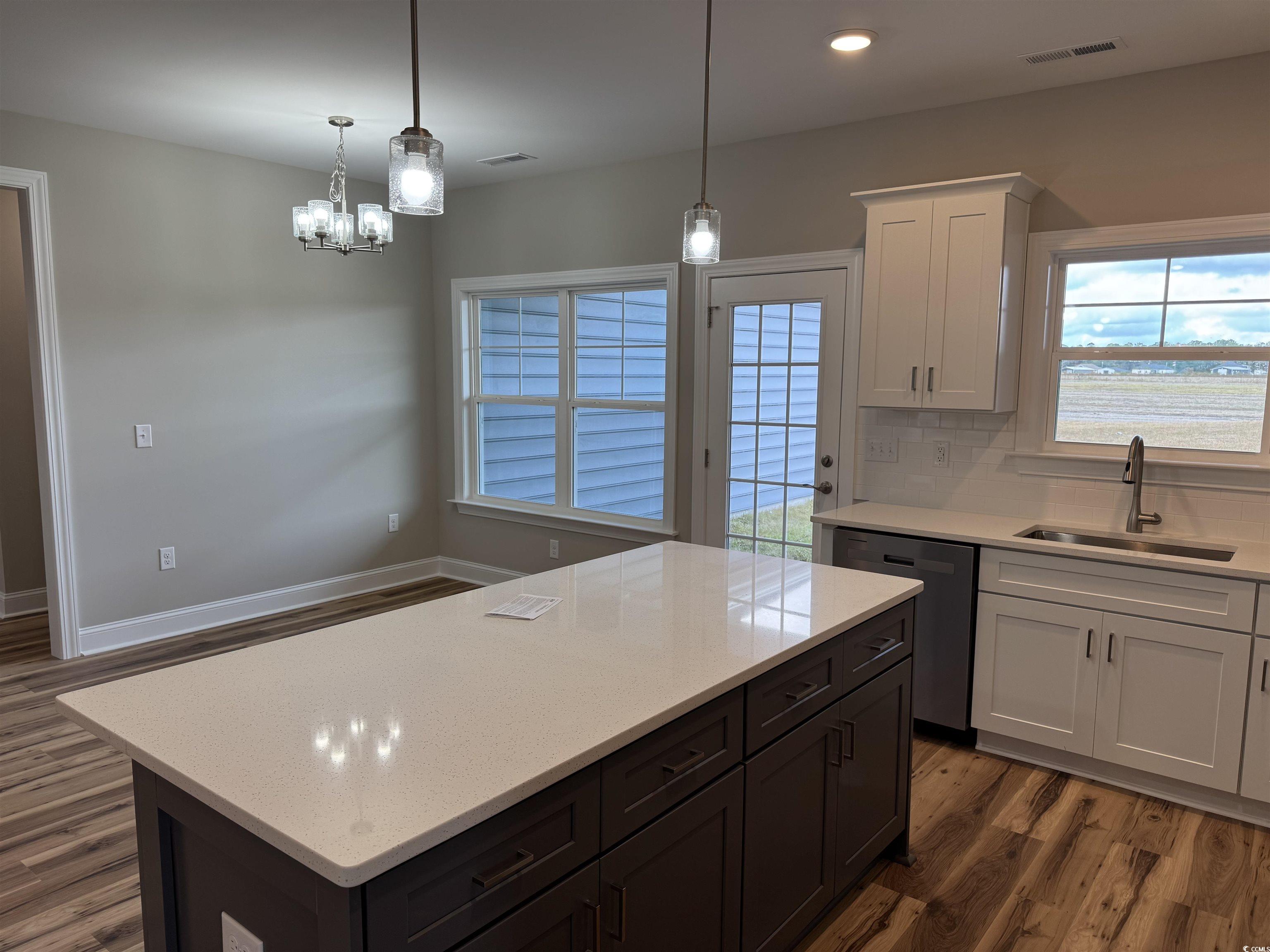 4963 Dupont Road Aynor, SC 29511 - Photo 6 of 18 Kitchen with dark wood-type flooring, white cabinets, decorative backsplash, light stone countertops, and recessed lighting