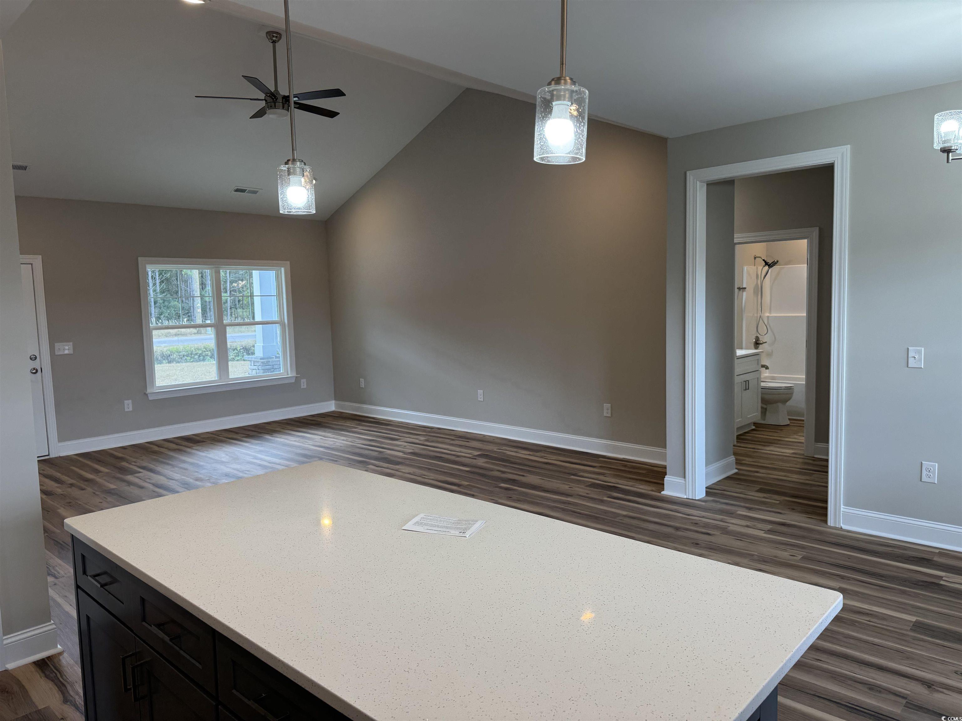 4963 Dupont Road Aynor, SC 29511 - Photo 18 of 18 Kitchen with dark wood-style floors, open floor plan, lofted ceiling, light stone countertops, and a center island
