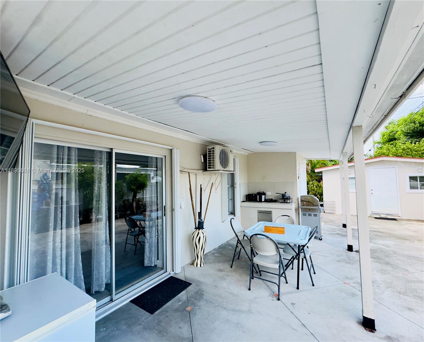 a view of a patio with table and chairs