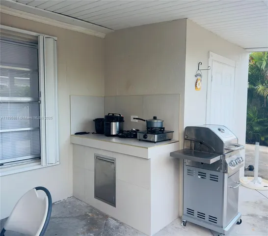 a kitchen with a appliances cabinets and a window