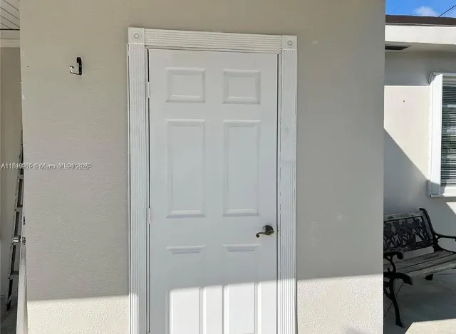 a view of a house with potted plants