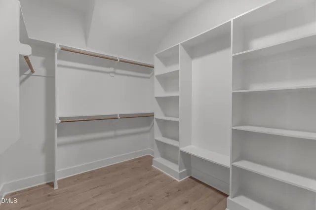 a bathroom with a double vanity sink toilet and a mirror