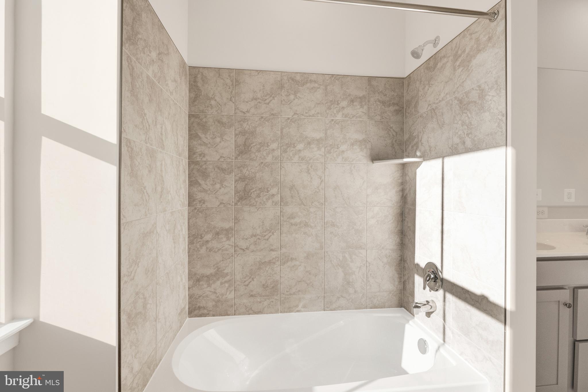 493 Mountain Laurel Boulevard Ranson, WV 25438 - Photo 16 of 27 a bathroom with a bathtub and a shower