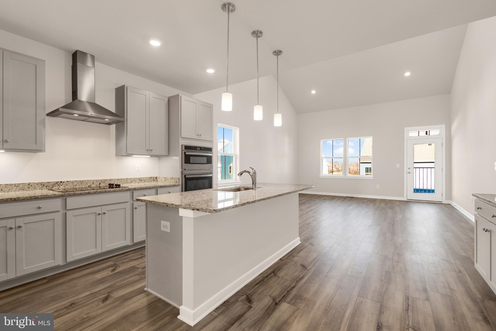 493 Mountain Laurel Boulevard Ranson, WV 25438 - Photo 2 of 27 a large kitchen with stainless steel appliances a large counter top a sink a refrigerator and a window