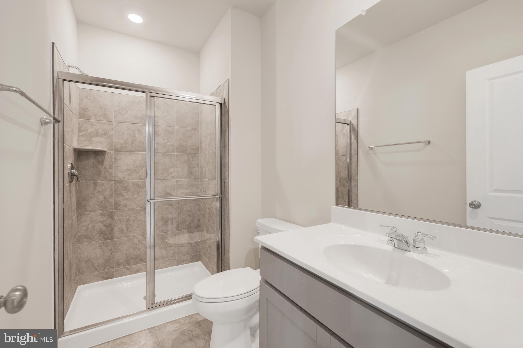 493 Mountain Laurel Boulevard Ranson, WV 25438 - Photo 24 of 27 a bathroom with a granite countertop sink toilet and shower