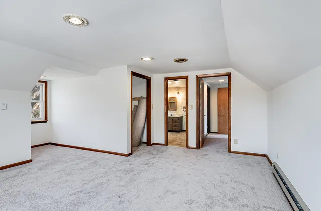 an empty room with closet and mirrors