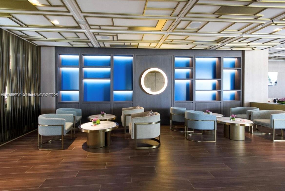 6899 Collins Avenue, Unit 1709 Miami Beach, FL 33141 - Photo 12 of 18 a living room with furniture and a wooden floor