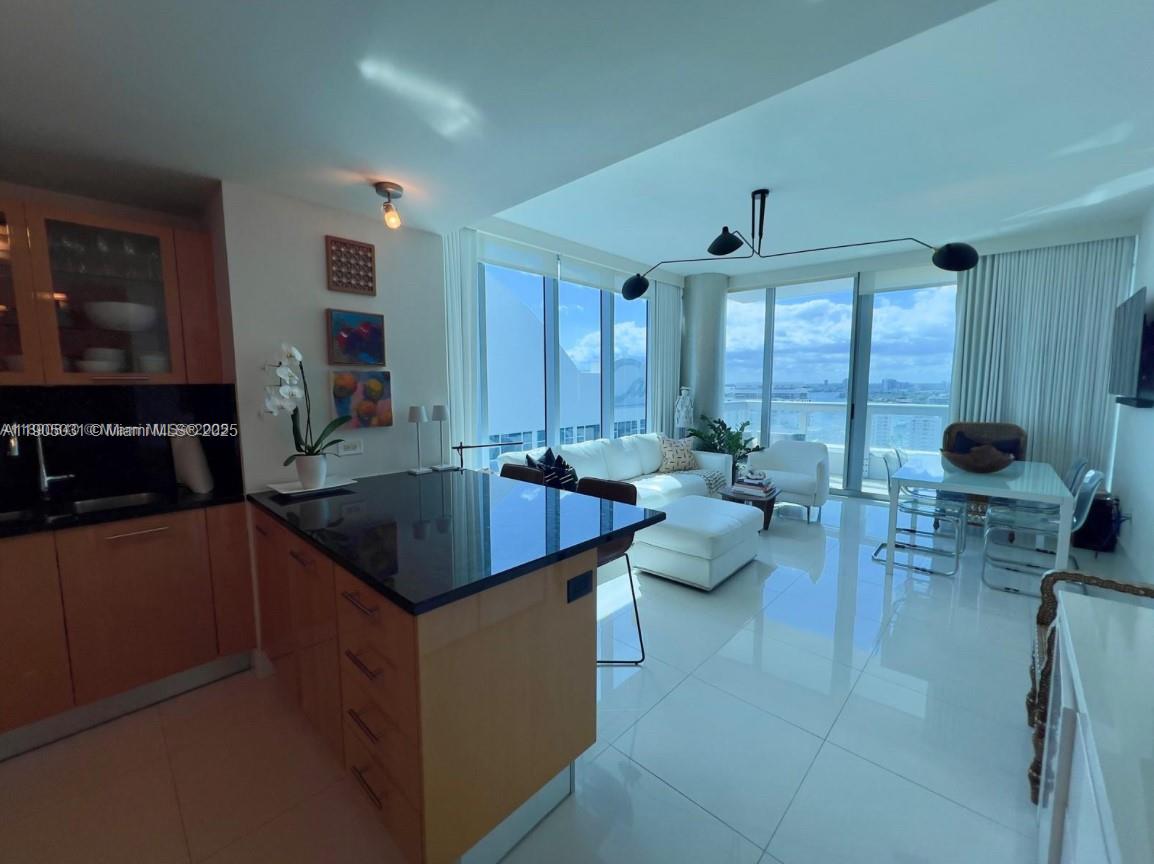 6899 Collins Avenue, Unit 1709 Miami Beach, FL 33141 - Photo 13 of 18 a kitchen with counter top space