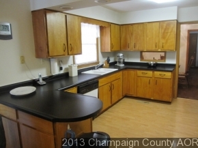 2332 Brookshire East Champaign, IL 61821 - Photo 7 of 15 a kitchen with stainless steel appliances granite countertop a sink a window and chairs