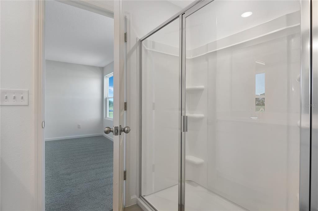 6169 Southwest 64th St Road Ocala, FL 34474 - Photo 15 of 25 a bathroom with a glass shower door