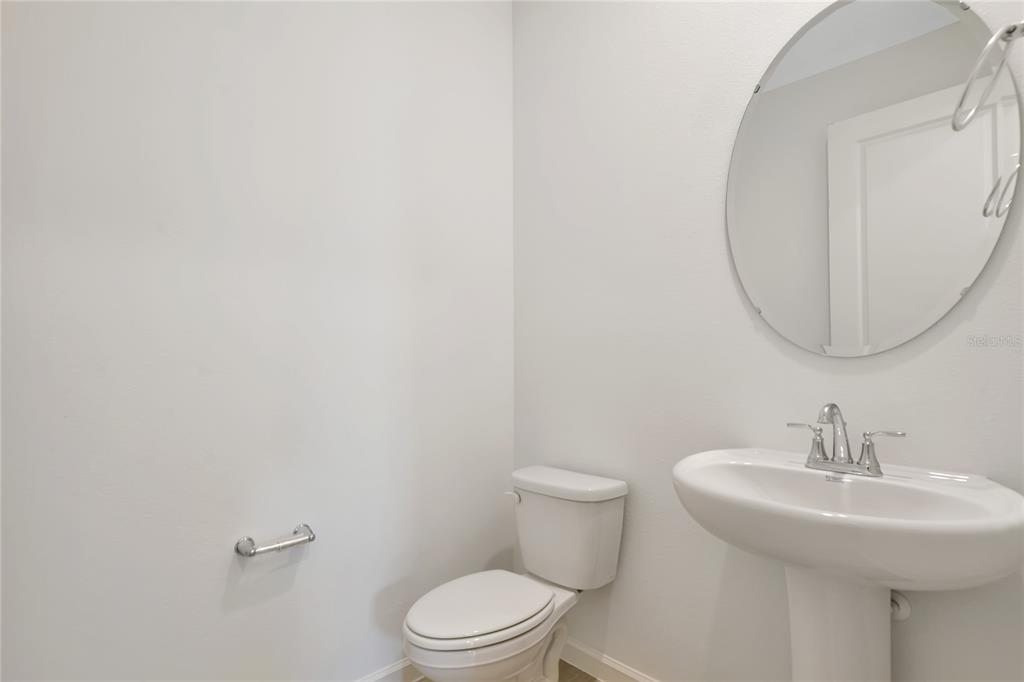 6169 Southwest 64th St Road Ocala, FL 34474 - Photo 6 of 25 a bathroom with a toilet a sink and mirror