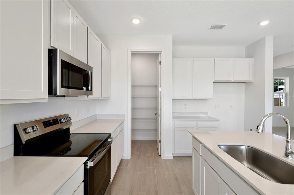 6169 Southwest 64th St Road Ocala, FL 34474 - Photo 9 of 25 a kitchen with a sink stove and microwave
