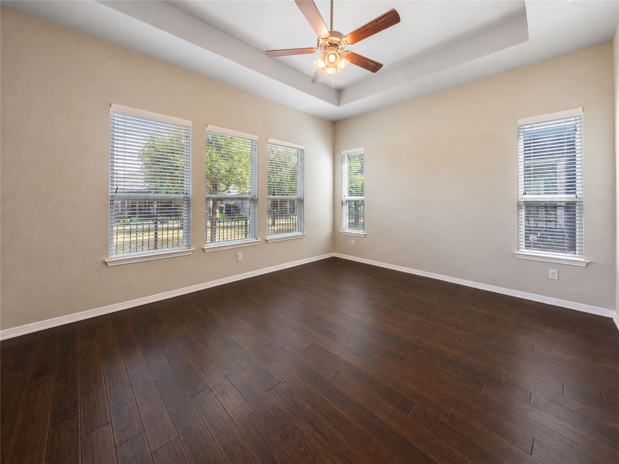 126 Rains Kyle, TX 78640 - Photo 18 of 22 Rich hardwood floors and a recessed tray ceiling define this versatile, light-filled space.