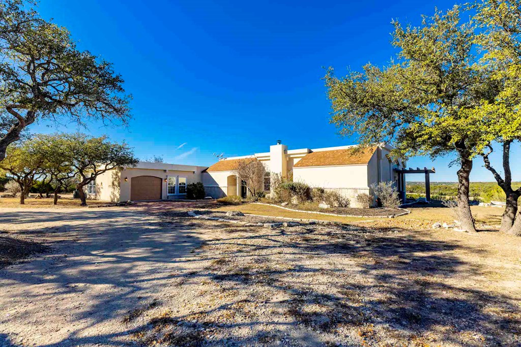 157 McCullough Ranch Road Kerrville, TX 78028 - Photo 18 of 75 a view of a house with a yard