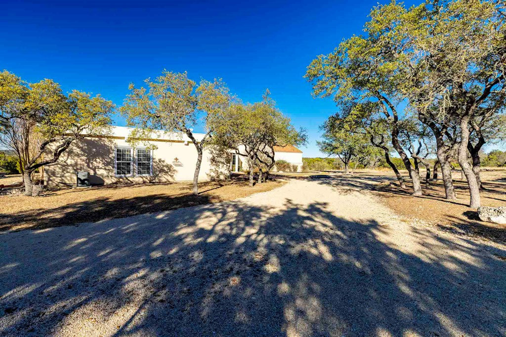 157 McCullough Ranch Road Kerrville, TX 78028 - Photo 19 of 75 a view of road with large trees