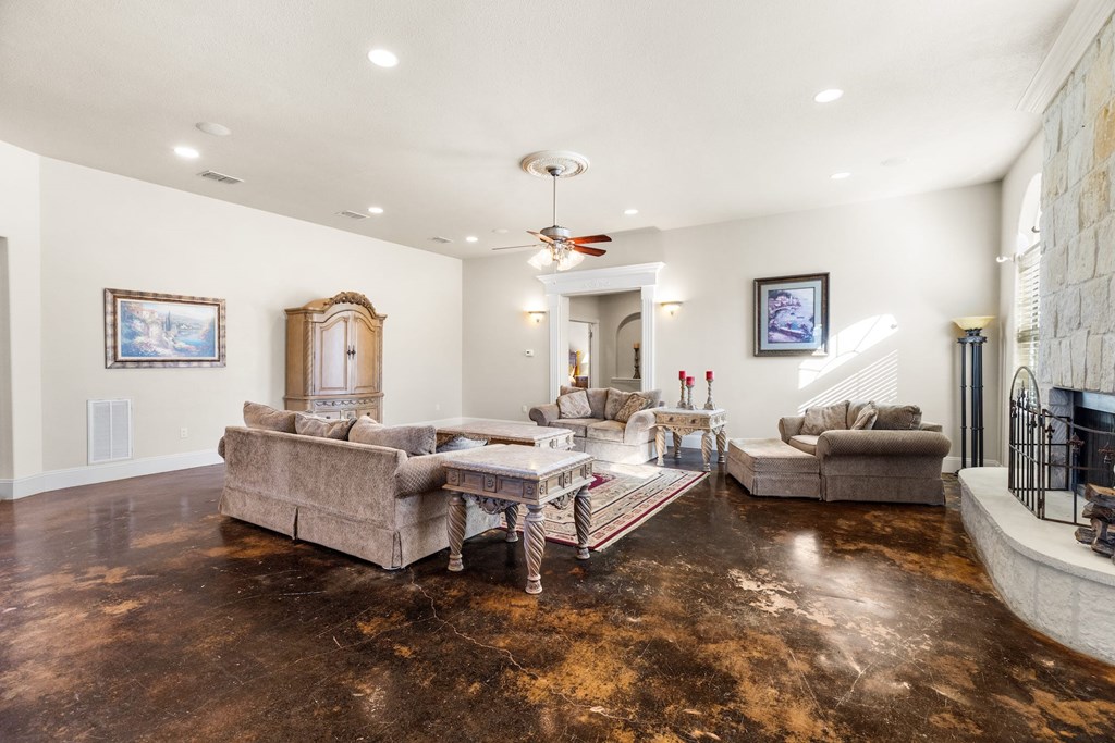 157 McCullough Ranch Road Kerrville, TX 78028 - Photo 28 of 75 a living room with fireplace furniture and a chandelier
