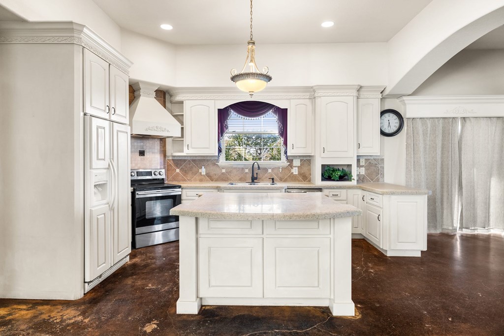 157 McCullough Ranch Road Kerrville, TX 78028 - Photo 29 of 75 a kitchen with stainless steel appliances granite countertop a sink cabinets and wooden floor