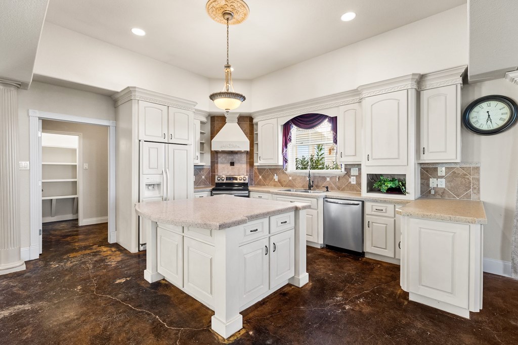 157 McCullough Ranch Road Kerrville, TX 78028 - Photo 30 of 75 a kitchen with white cabinets and window